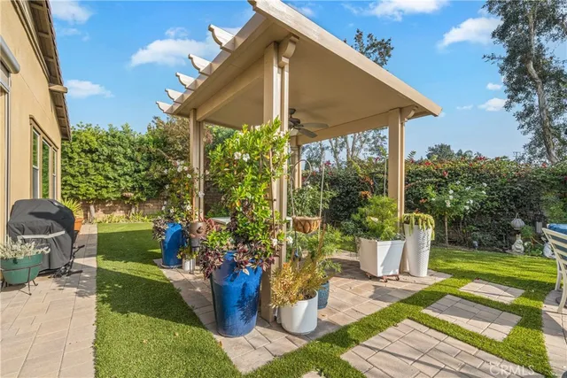 an aerial view of a house with a yard and outdoor seating