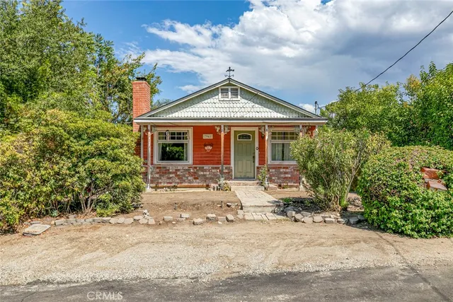 a front view of a house with yard porch and garage