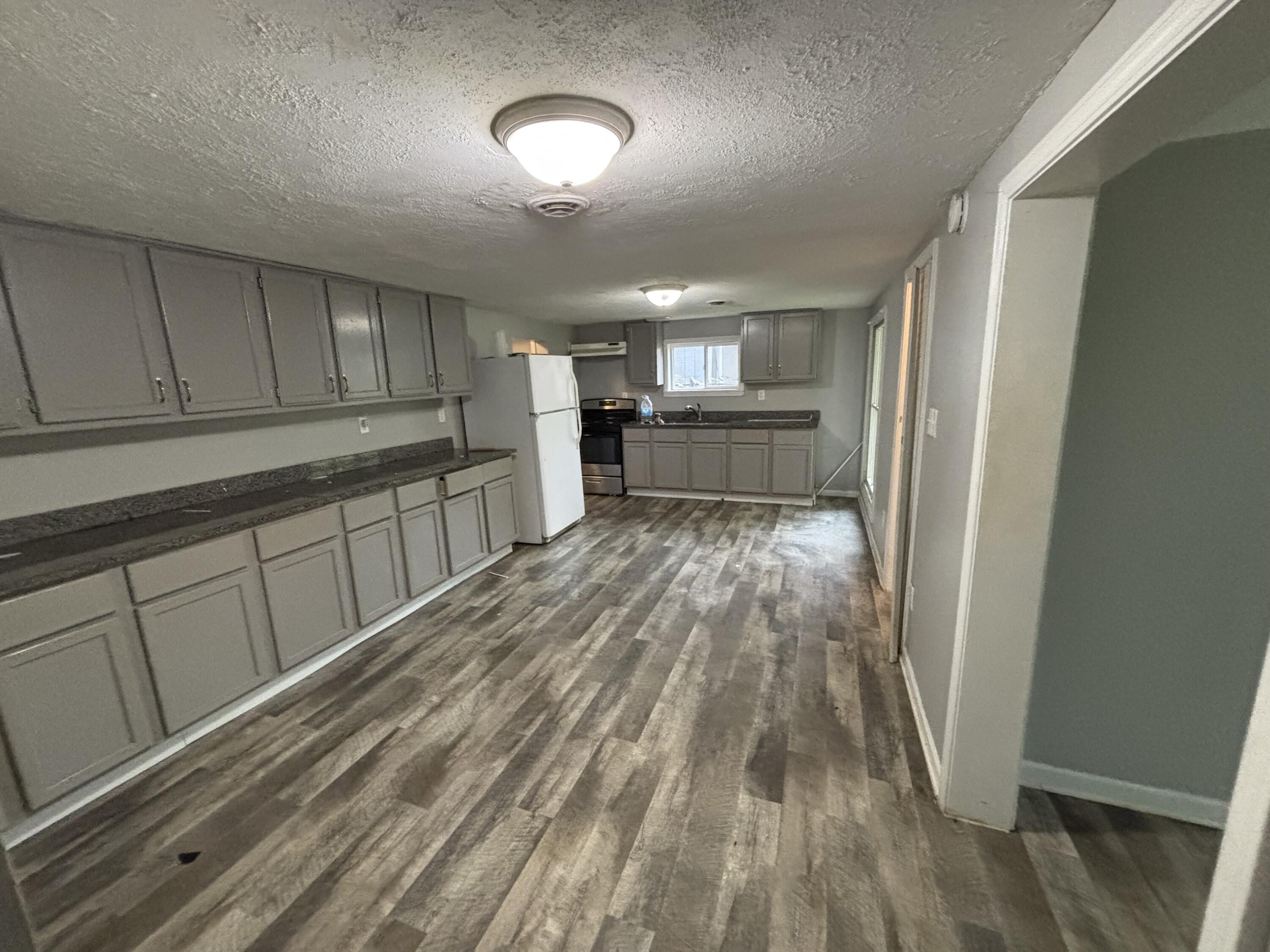 3512 West 48th Court Gary, IN 46408 - Photo 15 of 16 a view of a kitchen with a sink cabinets and window