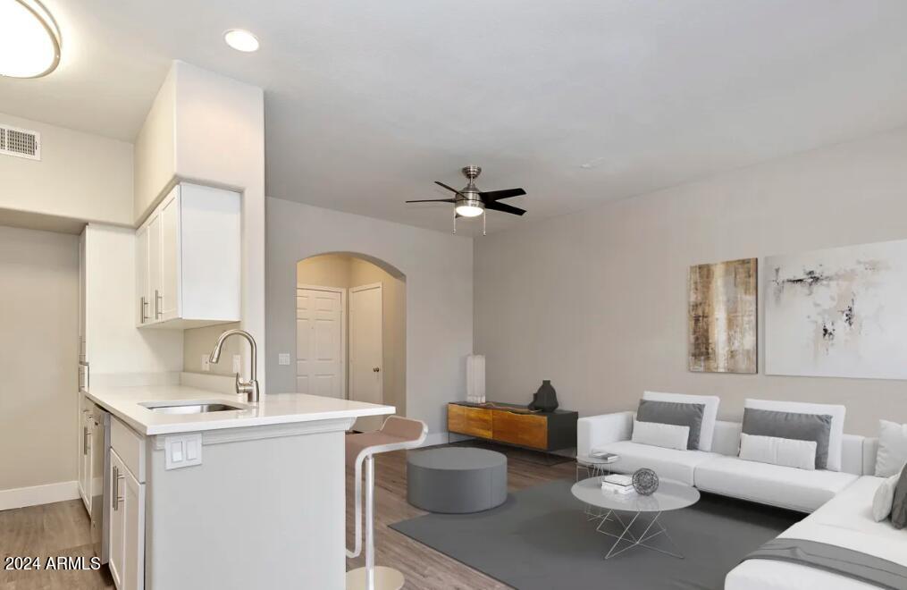 20808 North 27th Avenue, Unit A1 Phoenix, AZ 85027 - Photo 2 of 6 a living room with furniture and a sink