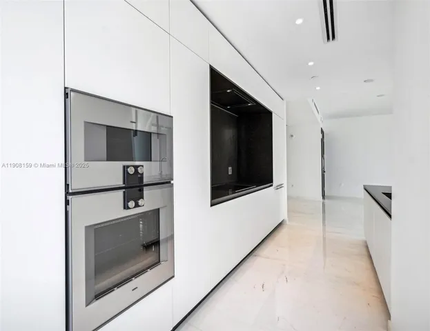 a kitchen with stainless steel appliances a stove microwave and sink