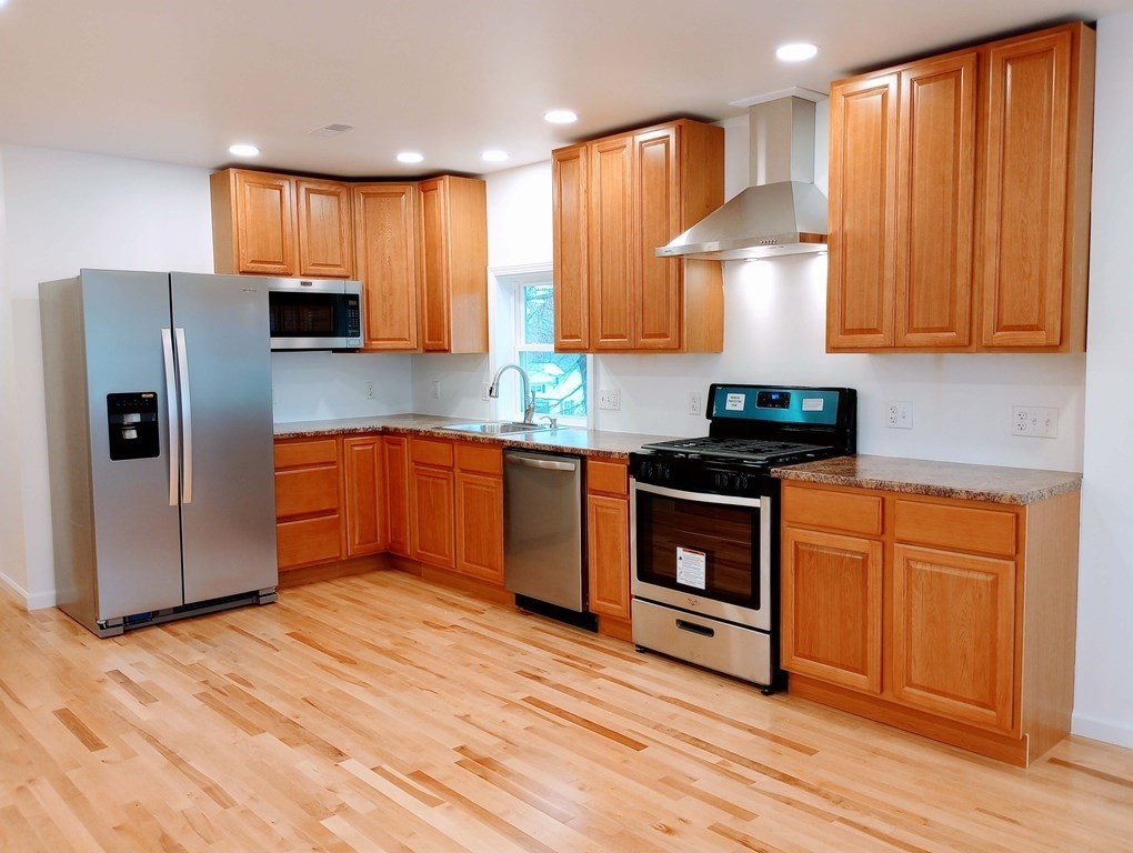 98 Gatewood Road Springfield, MA 01119 - Photo 3 of 21 a kitchen with stainless steel appliances granite countertop a refrigerator sink and cabinets