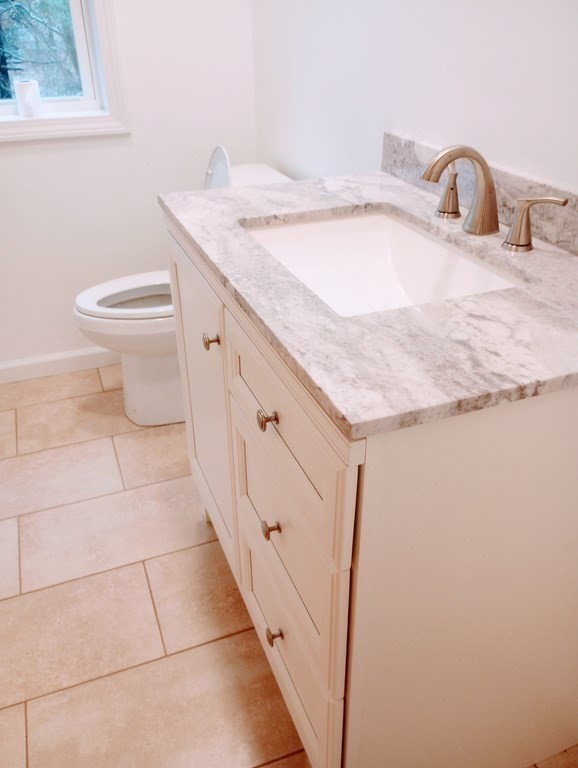 98 Gatewood Road Springfield, MA 01119 - Photo 9 of 21 a bathroom with a granite countertop sink a toilet and a mirror