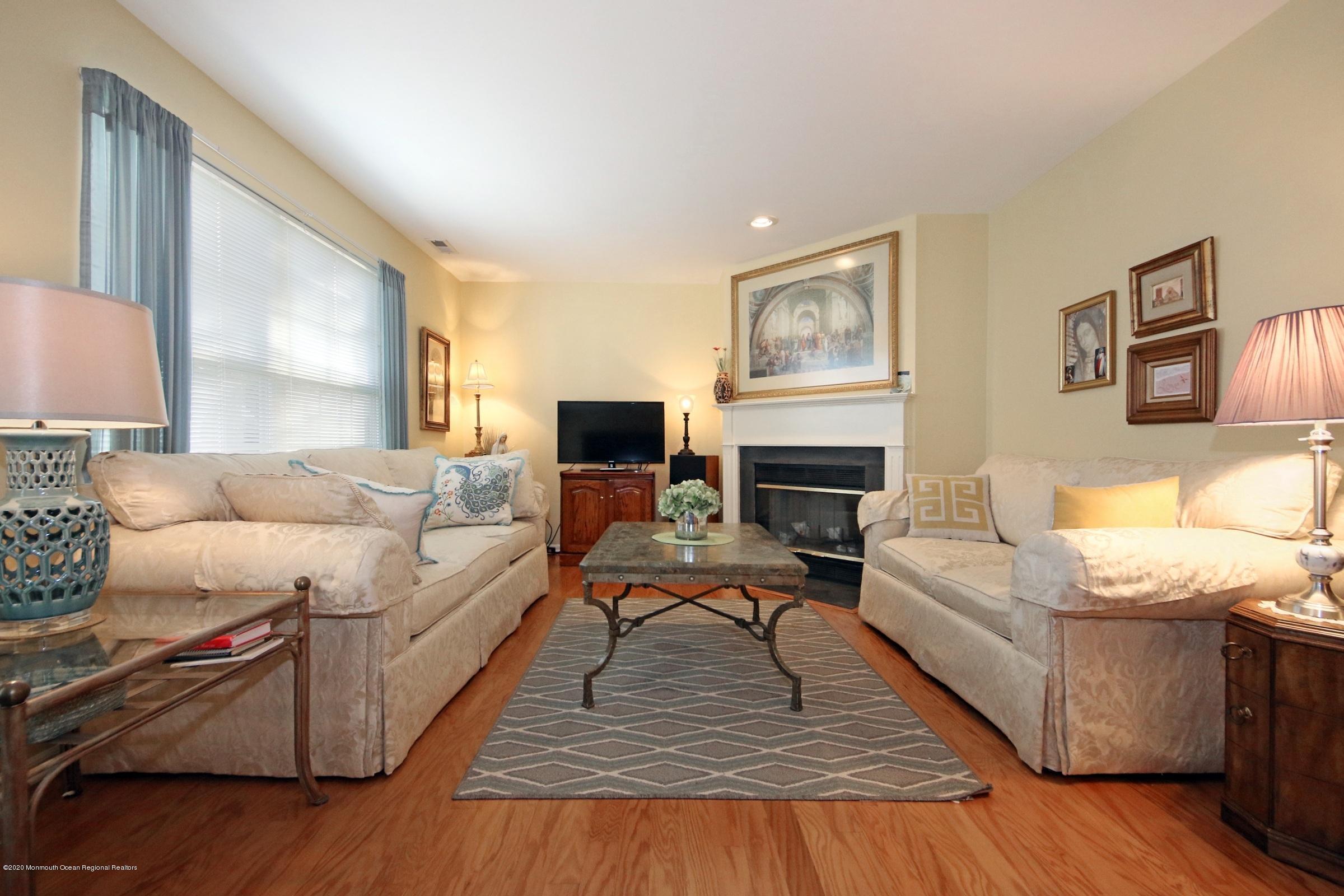 5 Racquet Road Wall, NJ 07719 - Photo 13 of 22 a living room with furniture or couch and a fireplace