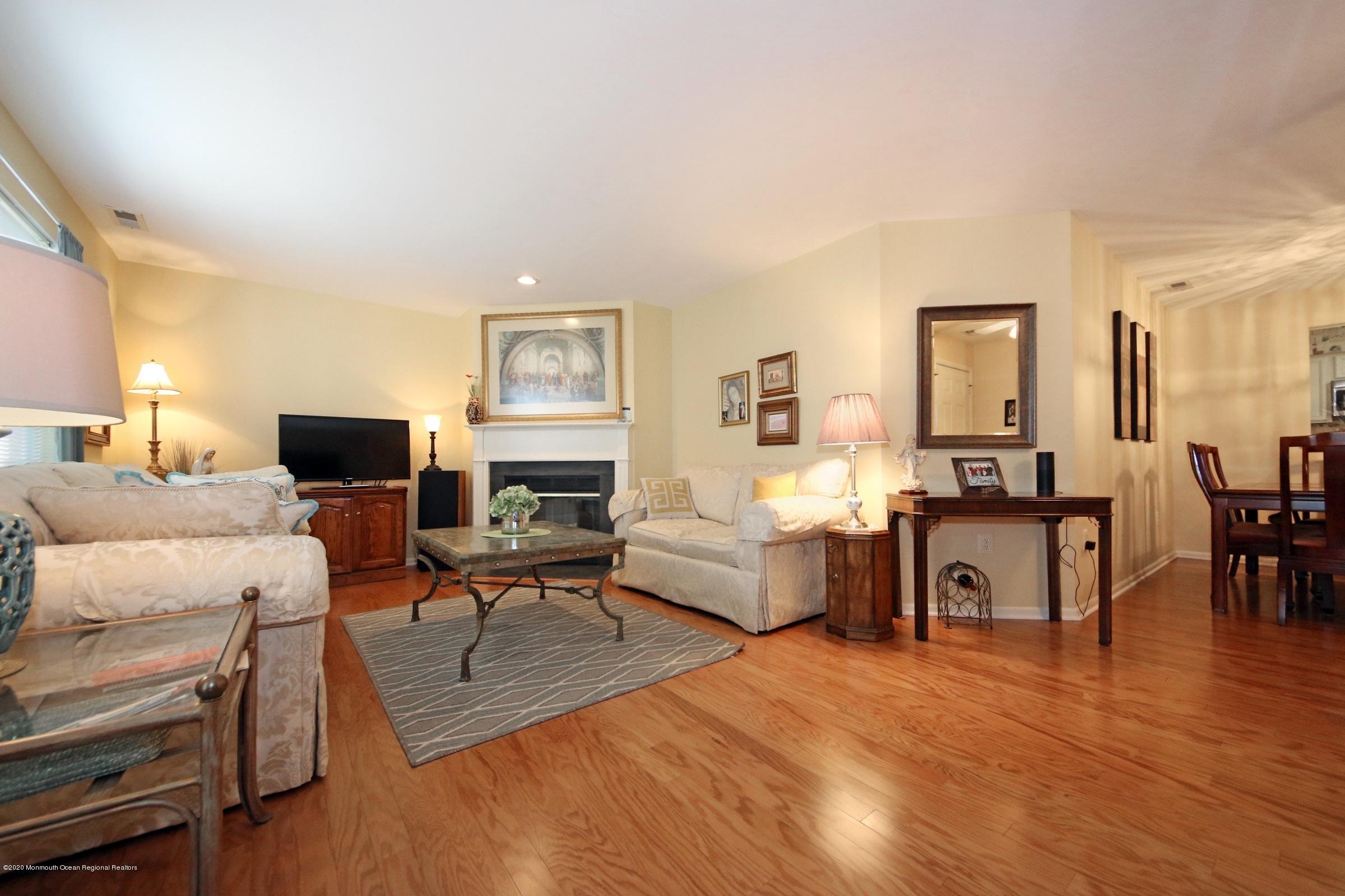 5 Racquet Road Wall, NJ 07719 - Photo 14 of 22 a living room with furniture a flat screen tv and a fireplace