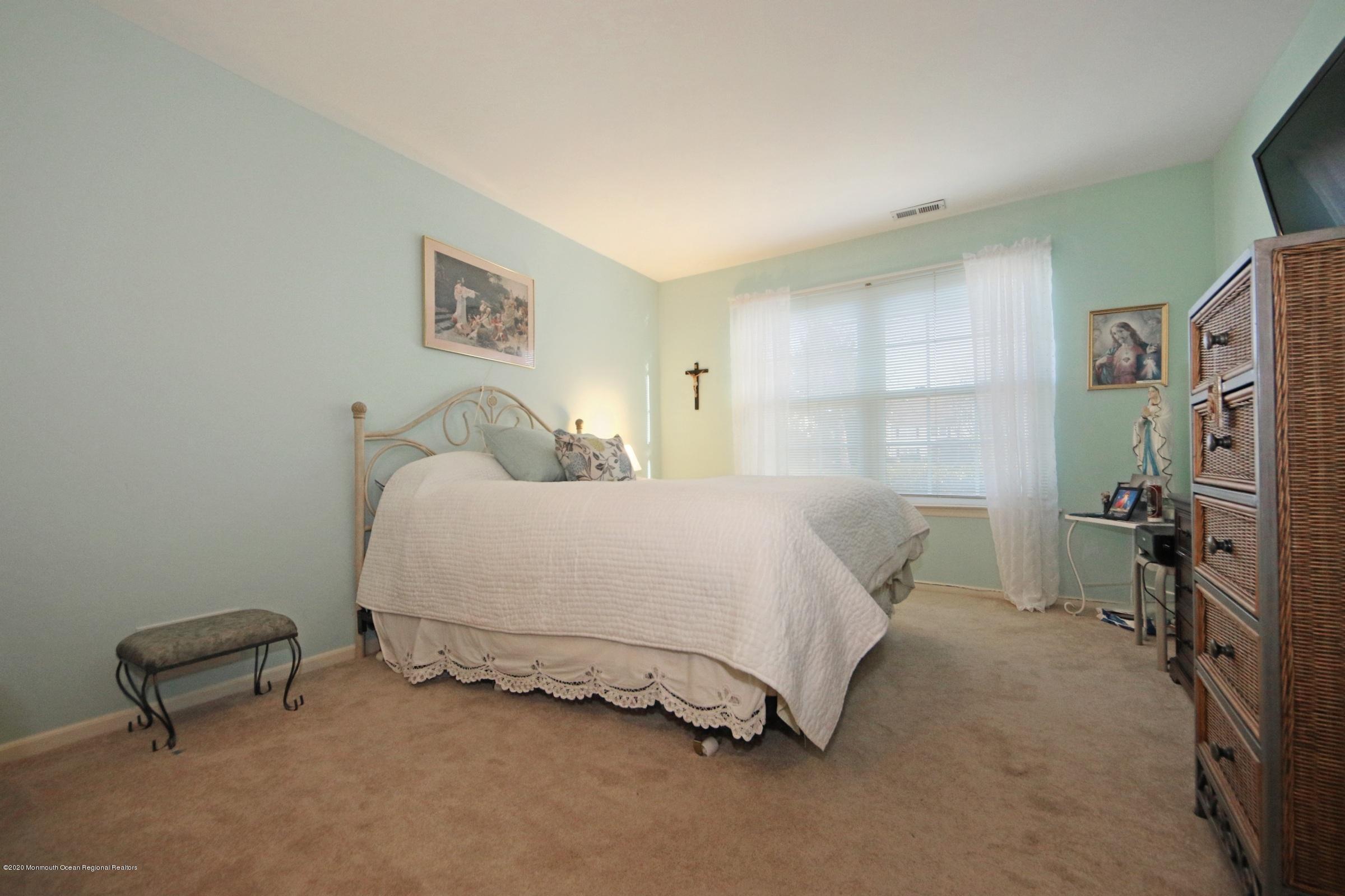 5 Racquet Road Wall, NJ 07719 - Photo 17 of 22 a bedroom with a bed and a chair