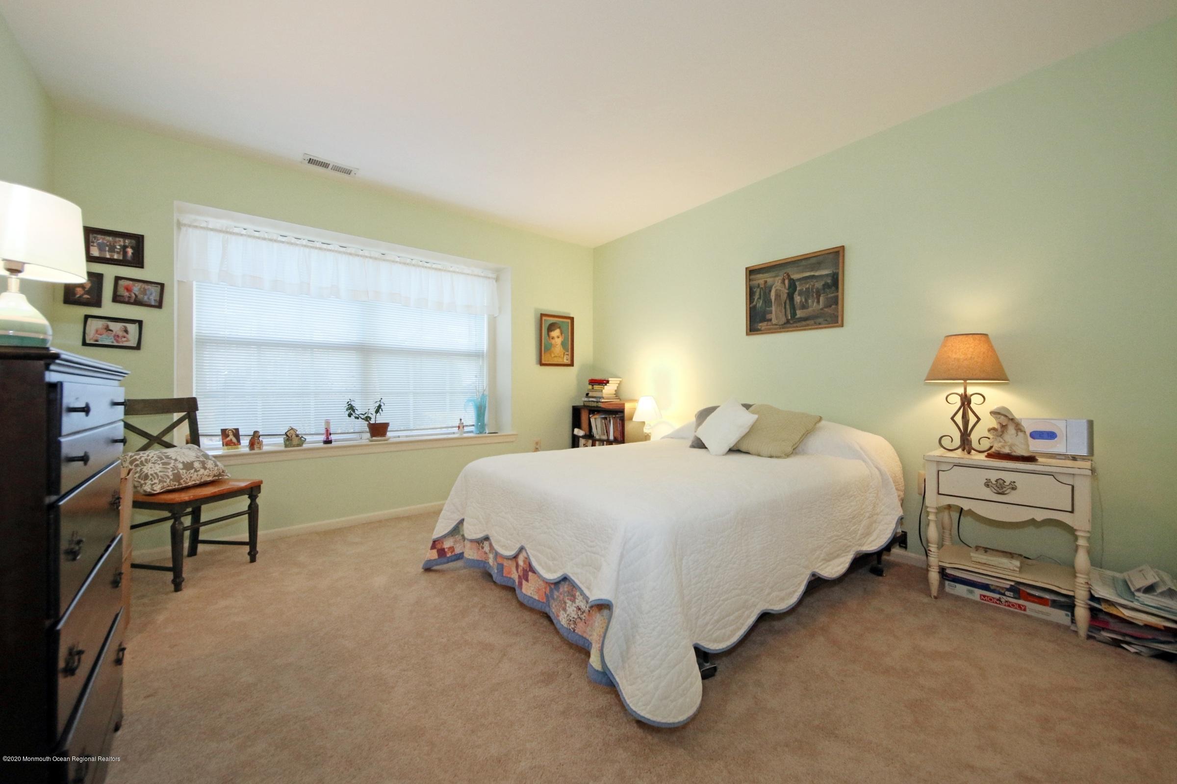 5 Racquet Road Wall, NJ 07719 - Photo 20 of 22 a spacious bedroom with a bed and a window