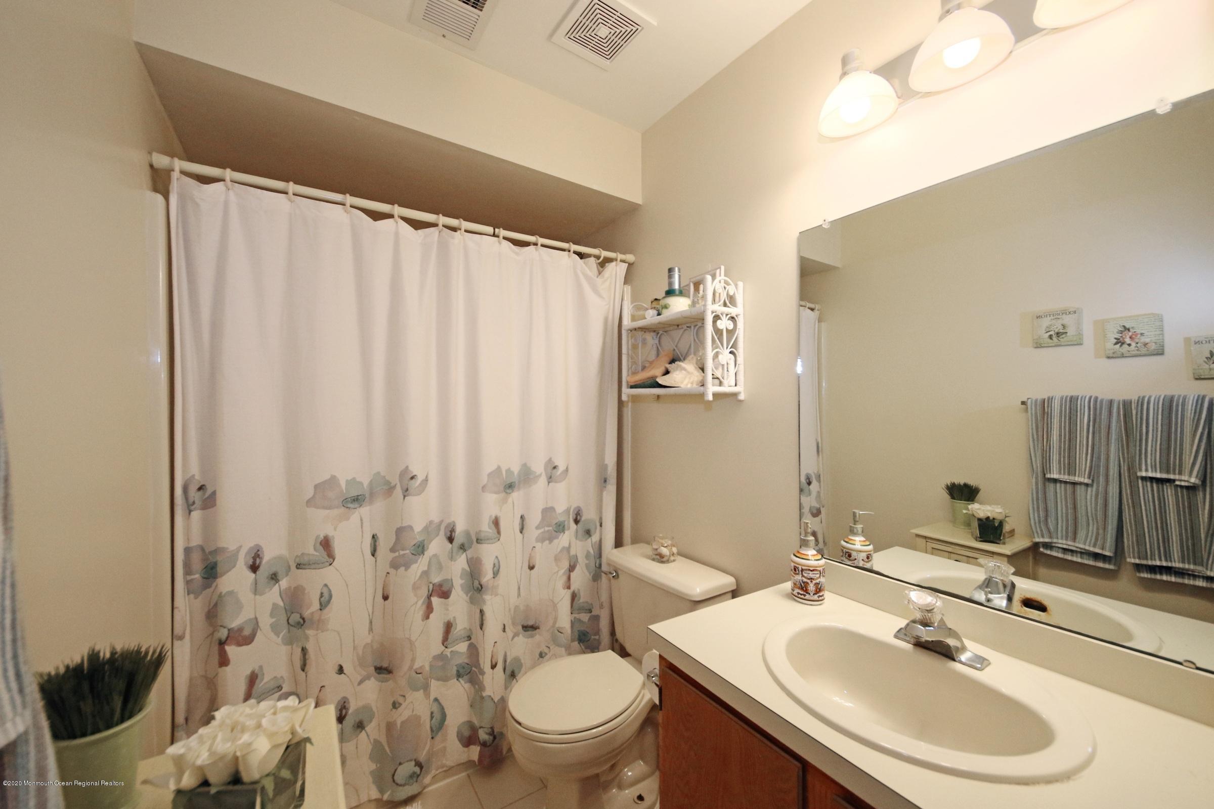 5 Racquet Road Wall, NJ 07719 - Photo 22 of 22 a bathroom with a sink toilet and shower