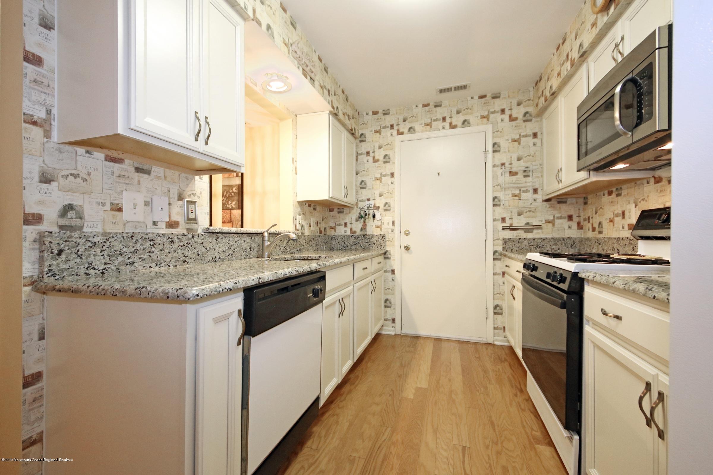 5 Racquet Road Wall, NJ 07719 - Photo 8 of 22 a kitchen with granite countertop a sink stove and refrigerator