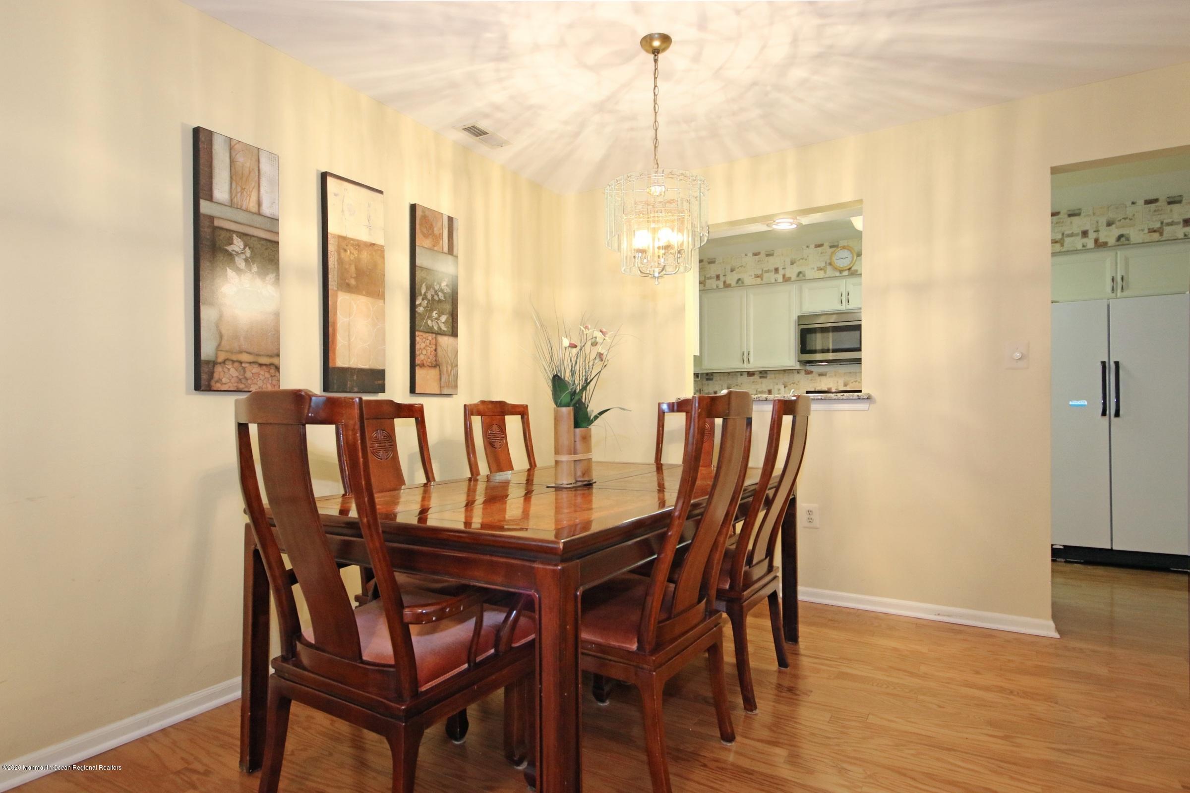 5 Racquet Road Wall, NJ 07719 - Photo 10 of 22 a view of a dining room with furniture and wooden floor