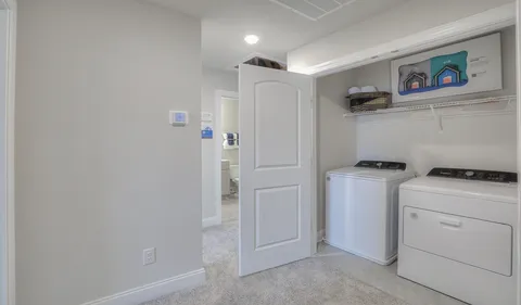 a view of storage and utility room with washer and dryer