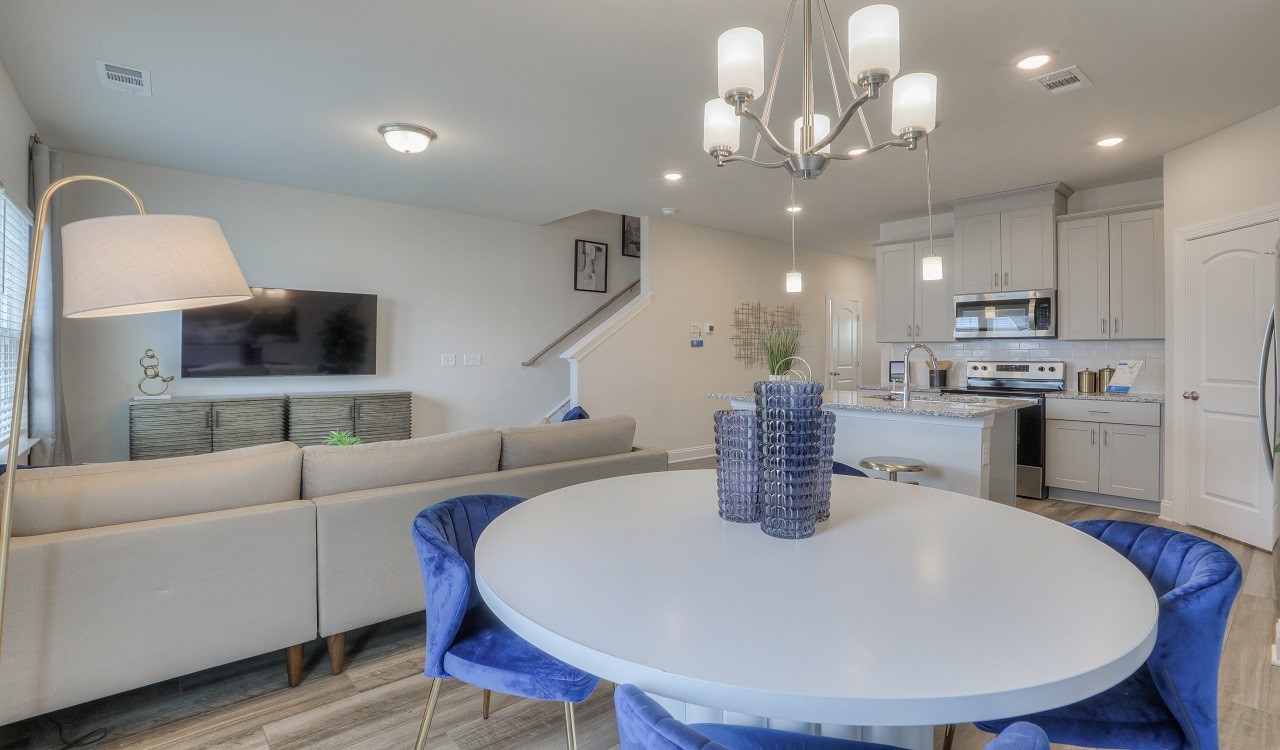 4677 Ridge Bend Drive Nashville, TN 37207 - Photo 6 of 14 a kitchen with stainless steel appliances granite countertop a sink dishwasher a microwave oven a dining table and chairs with wooden floor