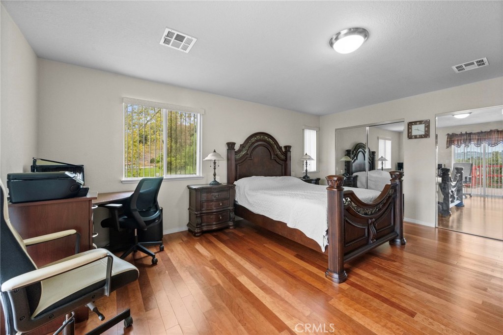 605 Bronco Way Walnut, CA 91789 - Photo 37 of 69 a bedroom with a bed and wooden floor