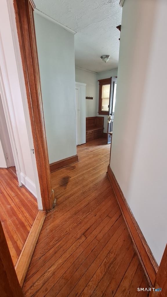 64-66 Ridge Street Manchester, CT 06040 - Photo 19 of 21 a view of a hallway with wooden floor and staircase