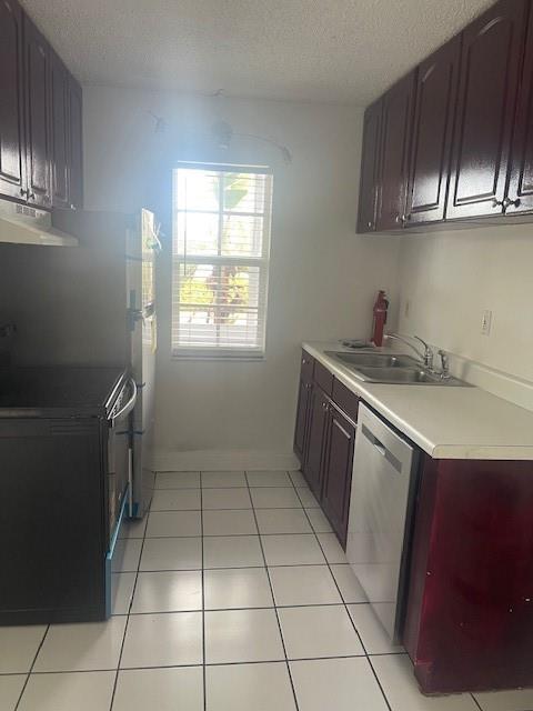 900 Northeast 26th Street, Unit 15 Wilton Manors, FL 33305 - Photo 4 of 9 a kitchen with a sink a stove and cabinets