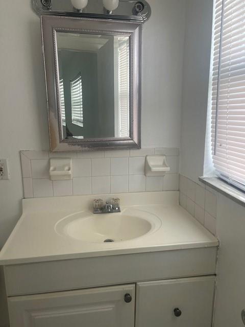900 Northeast 26th Street, Unit 15 Wilton Manors, FL 33305 - Photo 6 of 9 a bathroom with a sink and a mirror