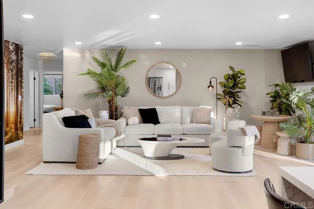 a view of living room kitchen with furniture and wooden floor