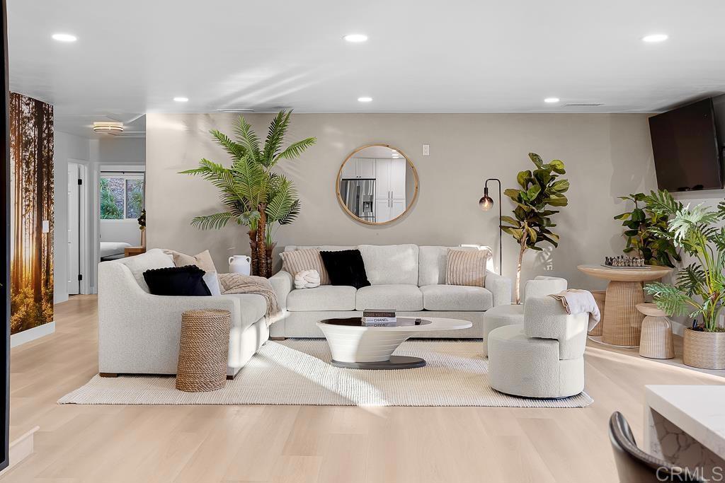 1286 Rippey Street El Cajon, CA 92020 - Photo 12 of 74 a living room with a couch and a potted plant