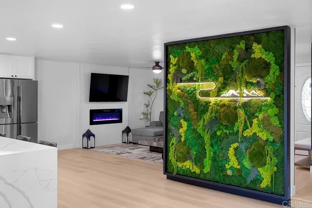 a bedroom with a large bed and a potted plant