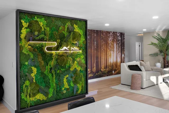 a spacious bedroom with a large bed and a potted plant