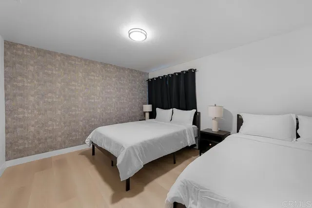 a view of a bedroom with a bed and a floor to ceiling window