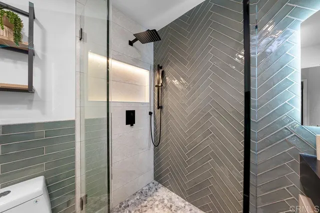 a bathroom with a toilet a sink and mirror