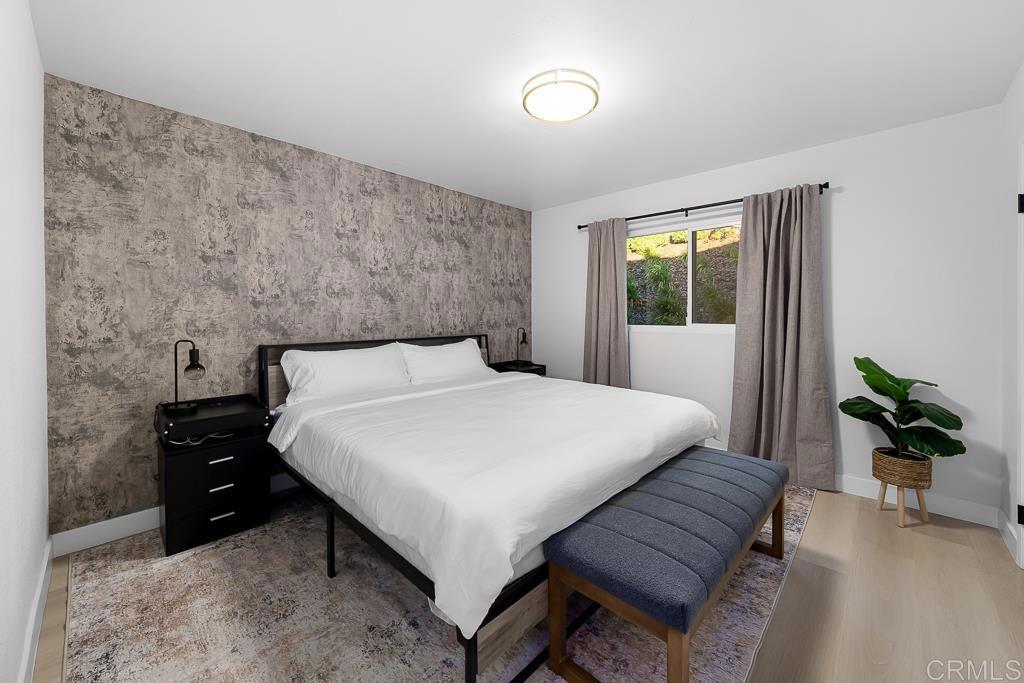 1286 Rippey Street El Cajon, CA 92020 - Photo 23 of 74 a bedroom with a bed table and a couch