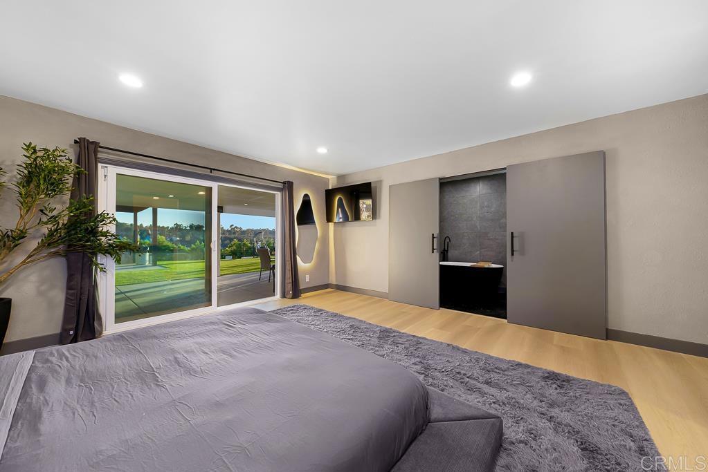 1286 Rippey Street El Cajon, CA 92020 - Photo 28 of 74 a view of a bedroom with a bed and a floor to ceiling window