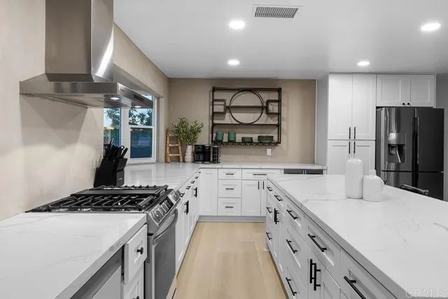 a kitchen with stainless steel appliances granite countertop a stove and a sink
