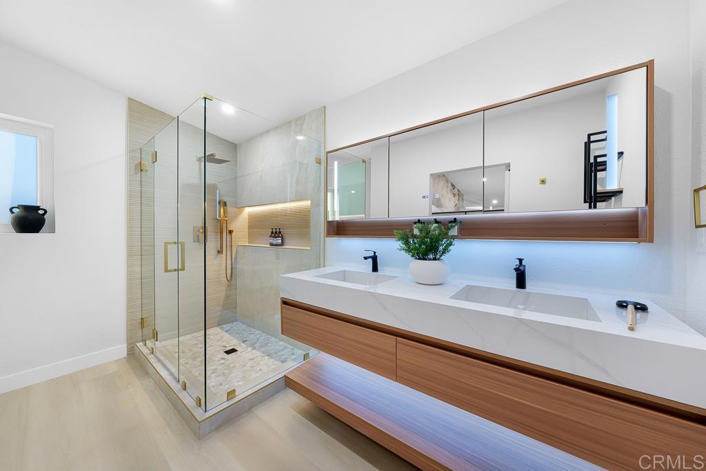 1286 Rippey Street El Cajon, CA 92020 - Photo 40 of 74 a bathroom with a double vanity sink mirror and shower
