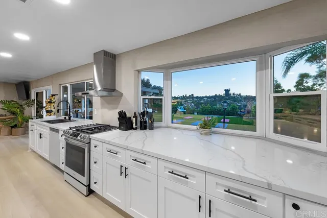 a view of kitchen with kitchen island granite countertop lots of counter top space