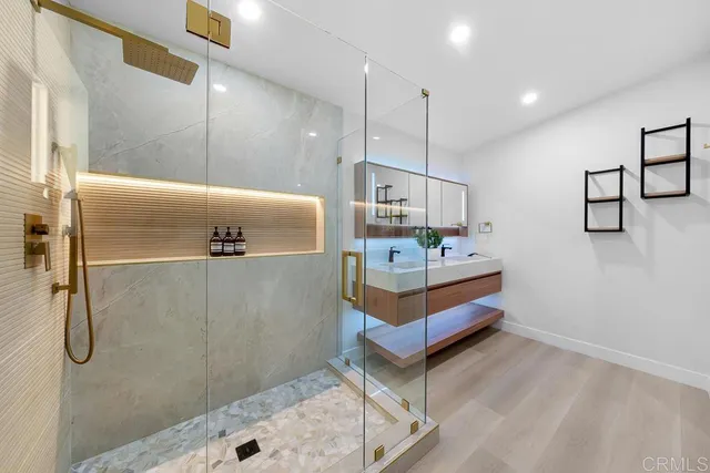 a view of a hallway with bathroom and mirror