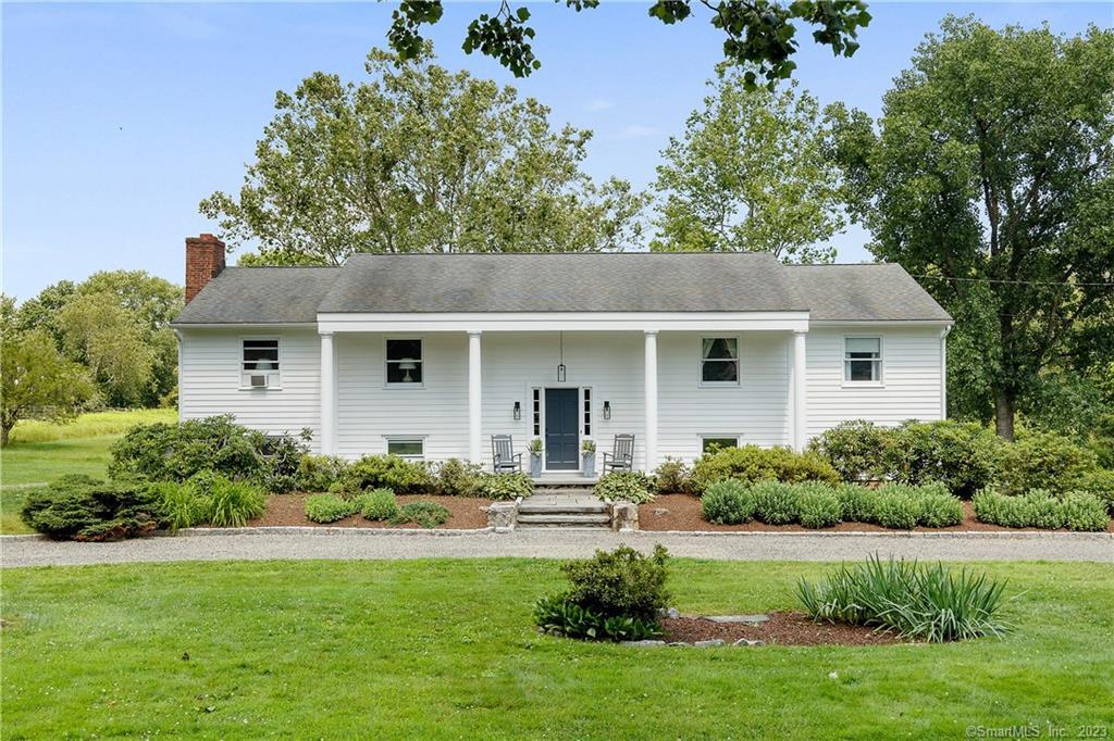 135 Highfield Road Wilton, CT 06897 - Photo 1 of 1 front view of a house with a yard