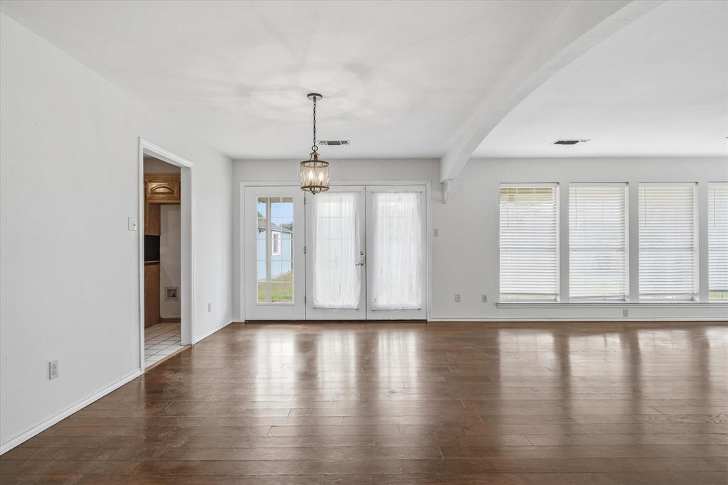 290 Sycamore Street Van, TX 75790 - Photo 11 of 38 a view of an empty room with wooden floor and a window