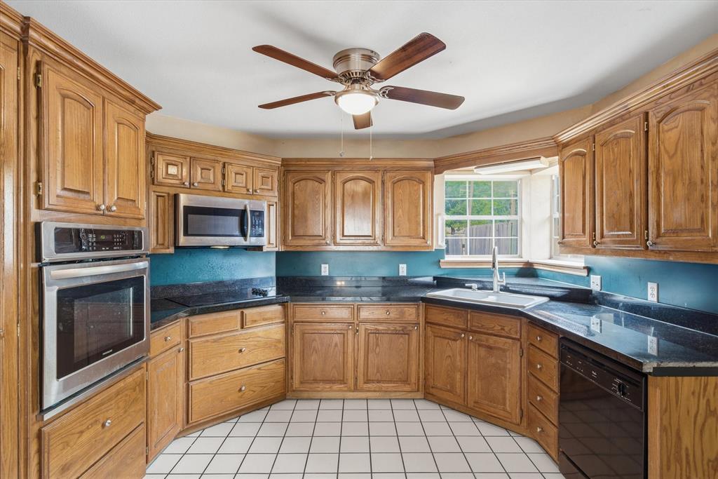 290 Sycamore Street Van, TX 75790 - Photo 12 of 38 a kitchen with a sink stove and microwave