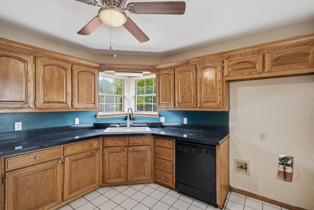 290 Sycamore Street Van, TX 75790 - Photo 13 of 38 a kitchen with stainless steel appliances granite countertop a sink and cabinets
