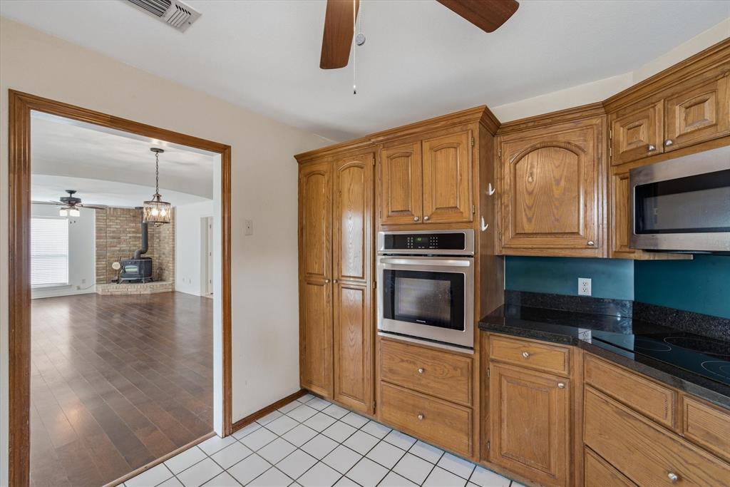 290 Sycamore Street Van, TX 75790 - Photo 14 of 38 a kitchen with stainless steel appliances granite countertop a refrigerator and a stove top oven