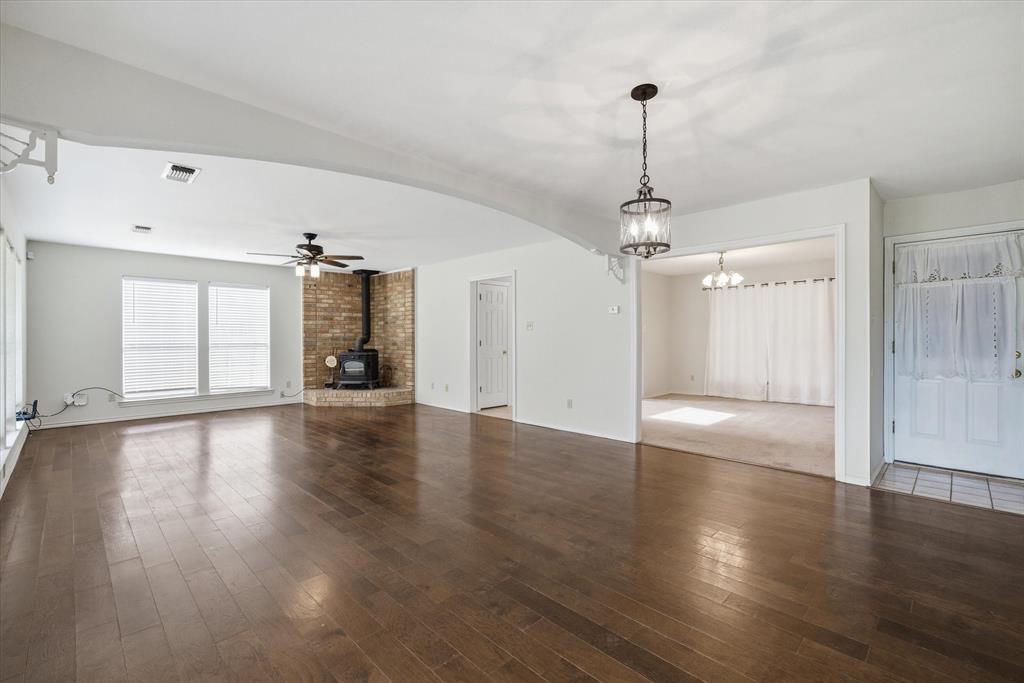 290 Sycamore Street Van, TX 75790 - Photo 15 of 38 a view of a room with wooden floor chandelier and windows