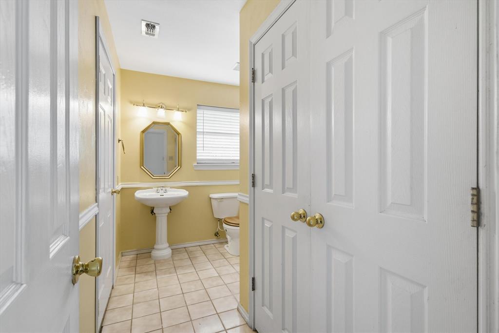 290 Sycamore Street Van, TX 75790 - Photo 16 of 38 a bathroom with a granite countertop sink a toilet and a mirror