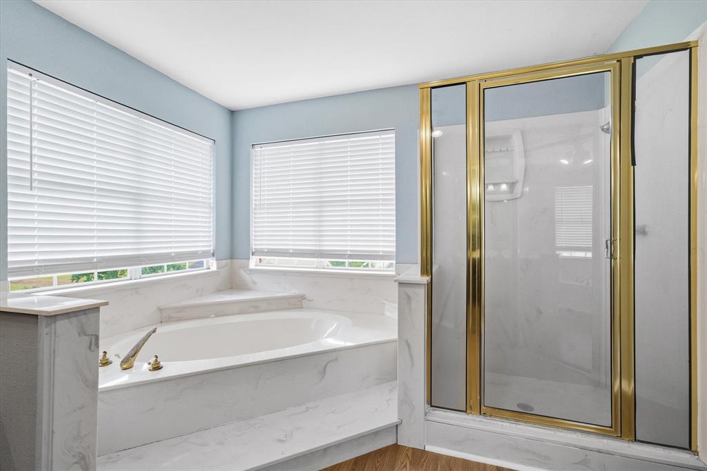 290 Sycamore Street Van, TX 75790 - Photo 21 of 38 a bathroom with a bathtub and a shower