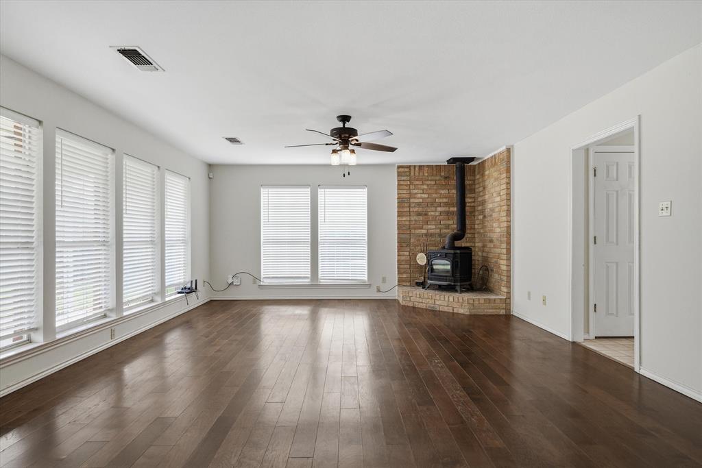 290 Sycamore Street Van, TX 75790 - Photo 8 of 38 an empty room with wooden floor chandelier and windows