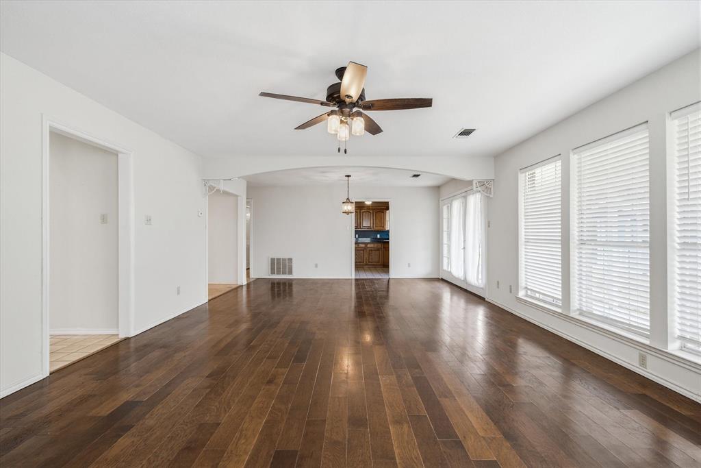 290 Sycamore Street Van, TX 75790 - Photo 9 of 38 a view of a livingroom with wooden floor and a ceiling fan