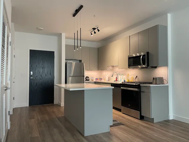 a kitchen with stainless steel appliances granite countertop a stove and a refrigerator