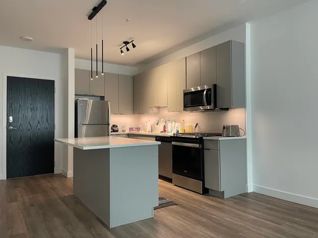 a kitchen with stainless steel appliances granite countertop a stove and a refrigerator