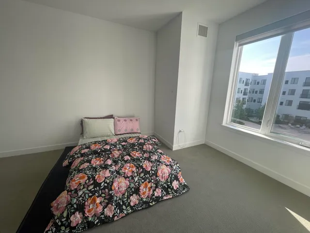 a bedroom with a bed and a window