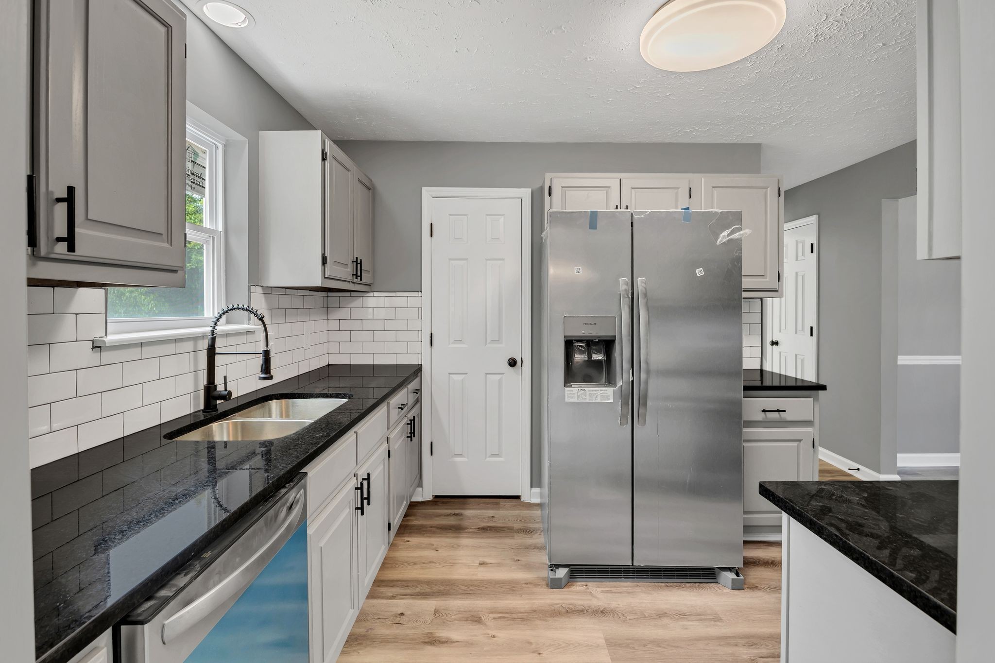 408 Hampstead South Antioch, TN 37013 - Photo 11 of 34 a kitchen with a sink a refrigerator and cabinets