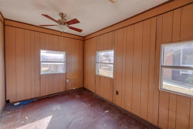 a view of entryway with wooden floor and cabinet