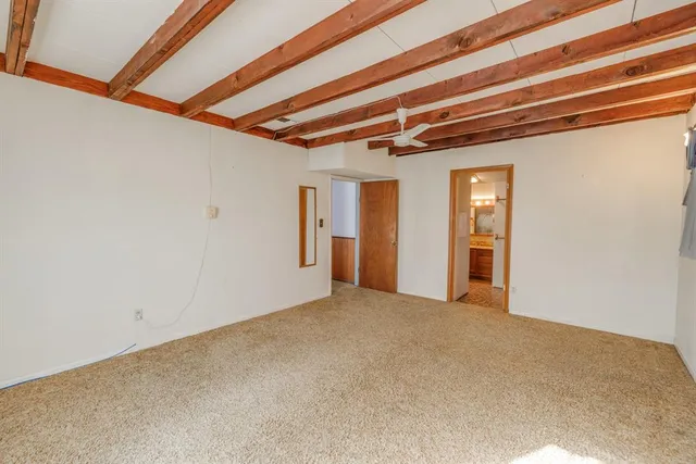 a view of a livingroom with wooden floor and a rug