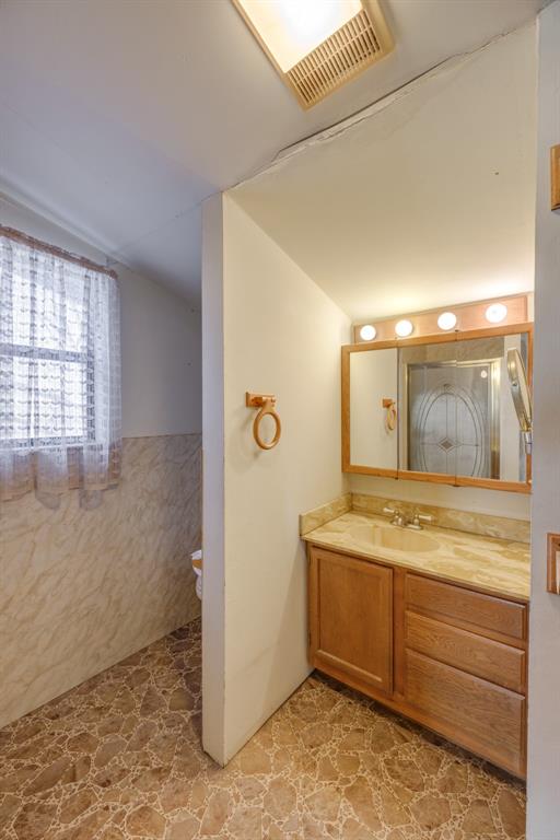 5 Angels Breath Road Abilene, TX 79601 - Photo 27 of 40 a bathroom with a granite countertop sink a mirror and a shower