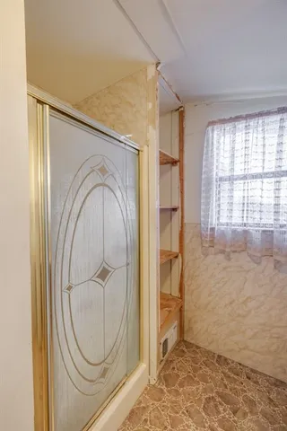 a view of a room with window and cabinet